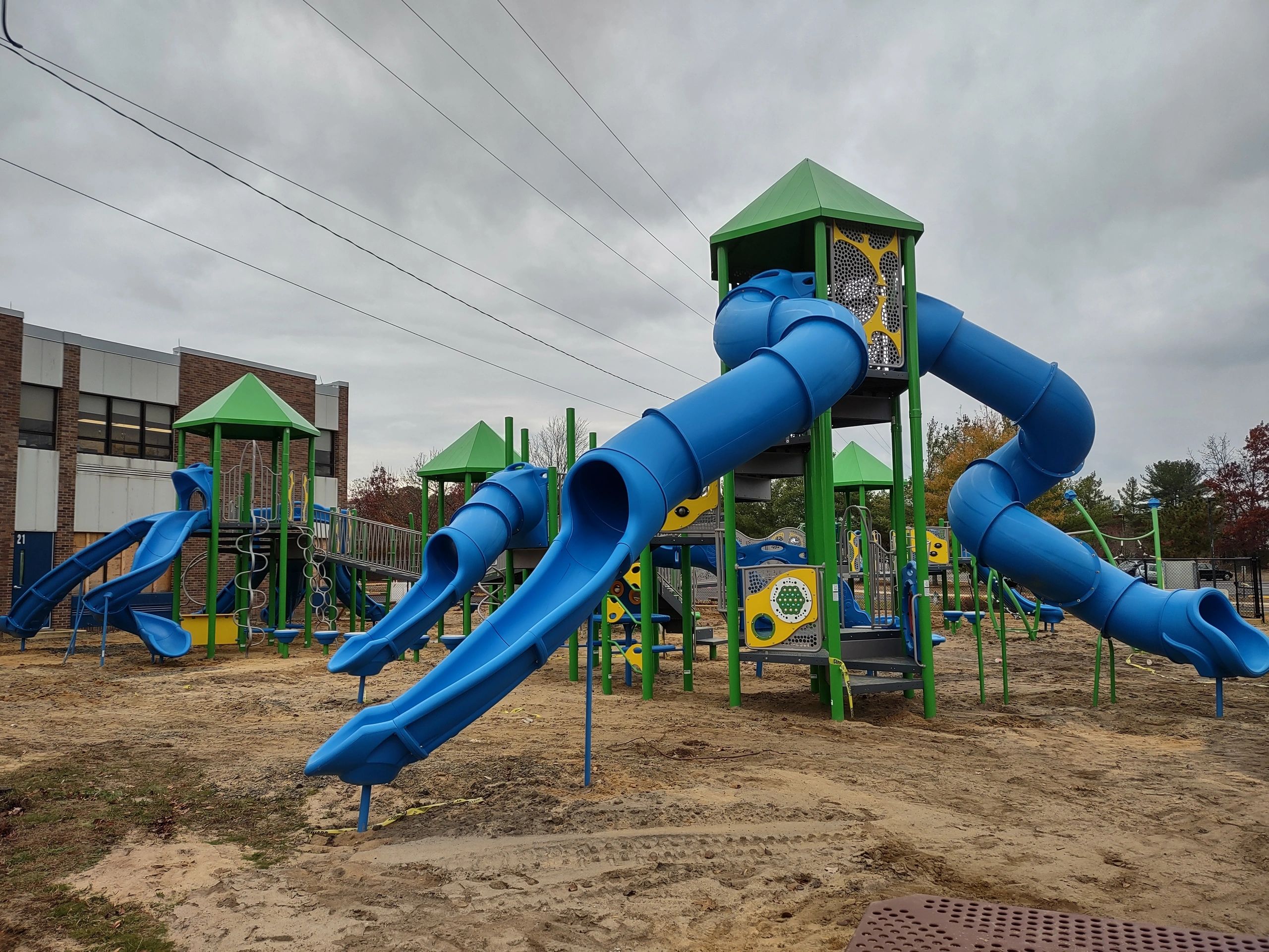 Children playground equipment with slides and towers